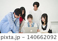 University students gathered around a computer 140662092