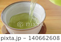 Pour Japanese green tea into a teacup. Pour Japanese green tea into a teacup. 140662608