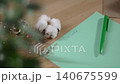 Turquoise sheet with child written words dear Santa lying on table at home, close up, no people. Beginning of letter for kind wizard, dreams of fulfilling child wishes on Christmas Eve. 140675599