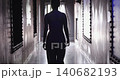 Woman silhouette walking down a dark hallway 140682193