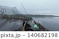 Large fish farm in the water with nets under cloudy sky as background 140682198