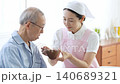A caregiver assisting an elderly person with eating 140689321