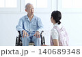 Caregivers who support elderly people in wheelchairs 140689348