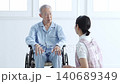 Caregivers who support elderly people in wheelchairs 140689349