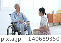 Caregivers who support elderly people in wheelchairs 140689350