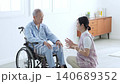 Caregivers who support elderly people in wheelchairs 140689352