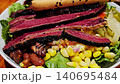 This is a salad with beef in the bowl 140695484