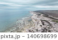 Aerial view of coastal landscape with rocky shore and calm ocean waters 140698699