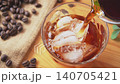 Iced coffee | Pour ice and coffee into a glass. Iced coffee | Pour ice and coffee into a glass. 140705421