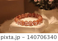 Tangerine stone bracelet displayed on rotating stand for viewing 140706340