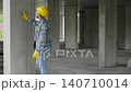 Construction worker inspecting concrete column on building site 140710014
