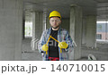 Construction worker making house shape with folding ruler 140710015