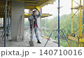 Exhausted construction worker taking a break on building site 140710016