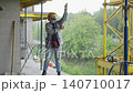 Construction worker measuring with tape on building site 140710017