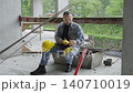 Construction worker taking phone call during break 140710019