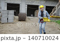 Construction worker carrying heavy formwork beam 140710024