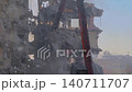 Excavator with hydraulic crusher is tearing down the building: slow motion 140711707