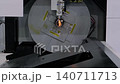 Slow motion: laser cutting machine is operating on metal workpiece with sparks 140711713