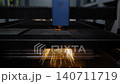 Laser cutting machine is operating on sheet metal with sparks 140711719
