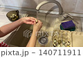 Washing eggs water, Cleaning small eggs under faucet, Rinsing tiny quail eggs thoroughly in kitchen sink faucet water, Using running water to carefully clean delicate quail eggs in kitchen sink 140711911