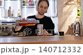 Cocktail making. Bartender work. Man pouring pink soda liquid from bottle in tall glass. Refreshing iced drink professional preparation. 140712332
