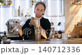 Mixing beverage. Barkeeper counter. Man professionally adding alcohol color flavored syrup with jigger to shaker preparing cocktail. 140712336