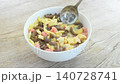 dry assorted flavor of cereal breakfast pouring fresh milk from bottle glass and scooping to eat on bowl 140728741