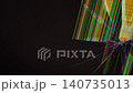 A shattered liquid crystal display showing vibrant vertical line defects and radiating glass fractures against a dark background, representing digital failure or broken device hardware 140735013