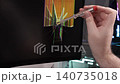 A person testing a cracked computer monitor with a voltage screwdriver to identify electrical issues, emphasizing professional tech maintenance and hardware repair diagnostic process 140735018