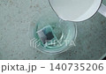 Pour hot water into the tea bag to brew butterfly pea tea. 140735206