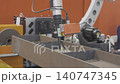 Robotic laser welding arm in automated manufacturing production line. Industrial robot metal welder. 140747345