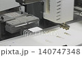 Pick and place machine assembling electronic component on production line. SMT automation working. 140747348