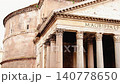 A view of the facade of the Pantheon in Rome, featuring ancient inscriptions and Corinthian columns. 140778650