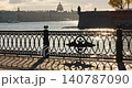 Isaac cathedral, Winter Palace, picturesque metal railings with a double-headed eagle and the crown of the Russian Empire on embankment in St. Petersburg, autumn sunset, incredible sun glare, Russia 140787090