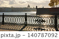 Isaac cathedral, Winter Palace, picturesque metal railings with a double-headed eagle and the crown of the Russian Empire on embankment in St. Petersburg, autumn sunset, incredible sun glare, Russia 140787092