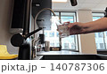 Woman pouring clean water into glass on kitchen, healthy lifestyle concept 140787306