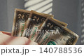 Hand holding several two dollar bills 140788536