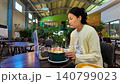 A stressed woman in a caffe is focused on her laptop 140799023