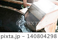 Hands touching the free-flowing cypress hot spring water 140804298