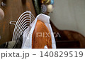 Golden brown sponge cake on a wire cooling rack with parchment paper 140829519
