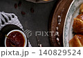Freshly Baked Hot Cross Buns with Jam on a Decorative Plate 140829524