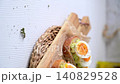 Avocado Toast with Soft Boiled Jammy Eggs on a Wooden Board 140829528