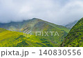 descending drone hyper lapse of green mountain slope under storm cloud in Kyrgyzstan 140830556