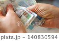 Female hands carefully counting polish zloty banknotes 140830594