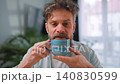 Happy man drinking coffee at relaxed home environment closeup. 140830599