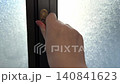 Woman hand opening and closing window handle, ventilation and privacy concept. 140841623