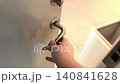 Woman opening public restroom door from inside, exit concept. 140841628