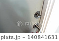 Woman locking door from inside, privacy and security concept. 140841631