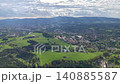 Aerial view suburban greenbelt and town with residential blocks, sports fields and winding roads, distant 140885587