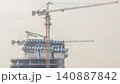 Concrete skyscraper construction daytime timelapse Dubai a hazy sky aerial 140887842